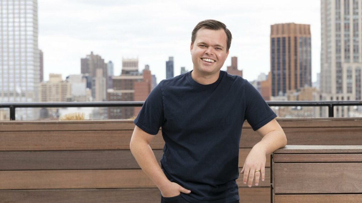 Allen Osgood, co-founder and CEO of Eisen, in front of the New York City skyline