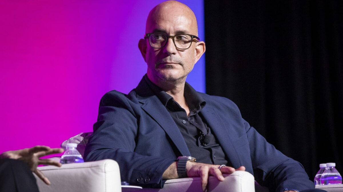 Securitize CEO Carlos Domingo looks to the far right during a conference.