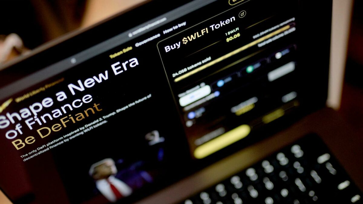 A laptop screen shows World Liberty Financial's website