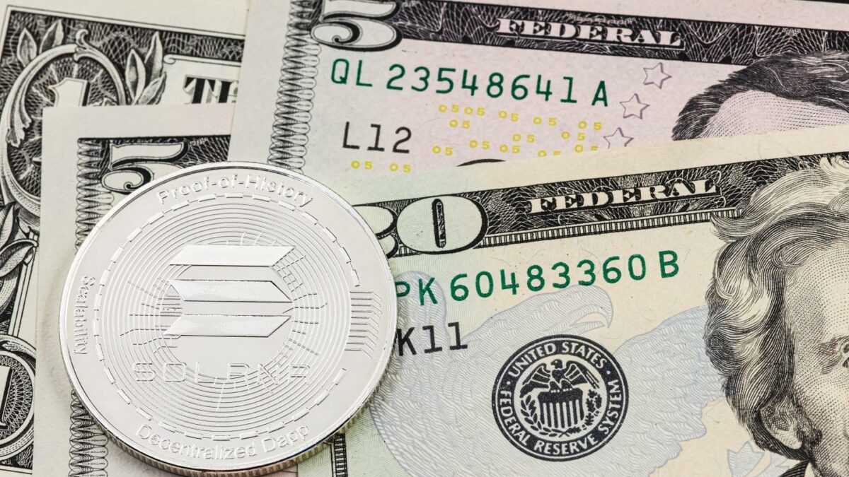 A Solana token sits on top of several cash bills