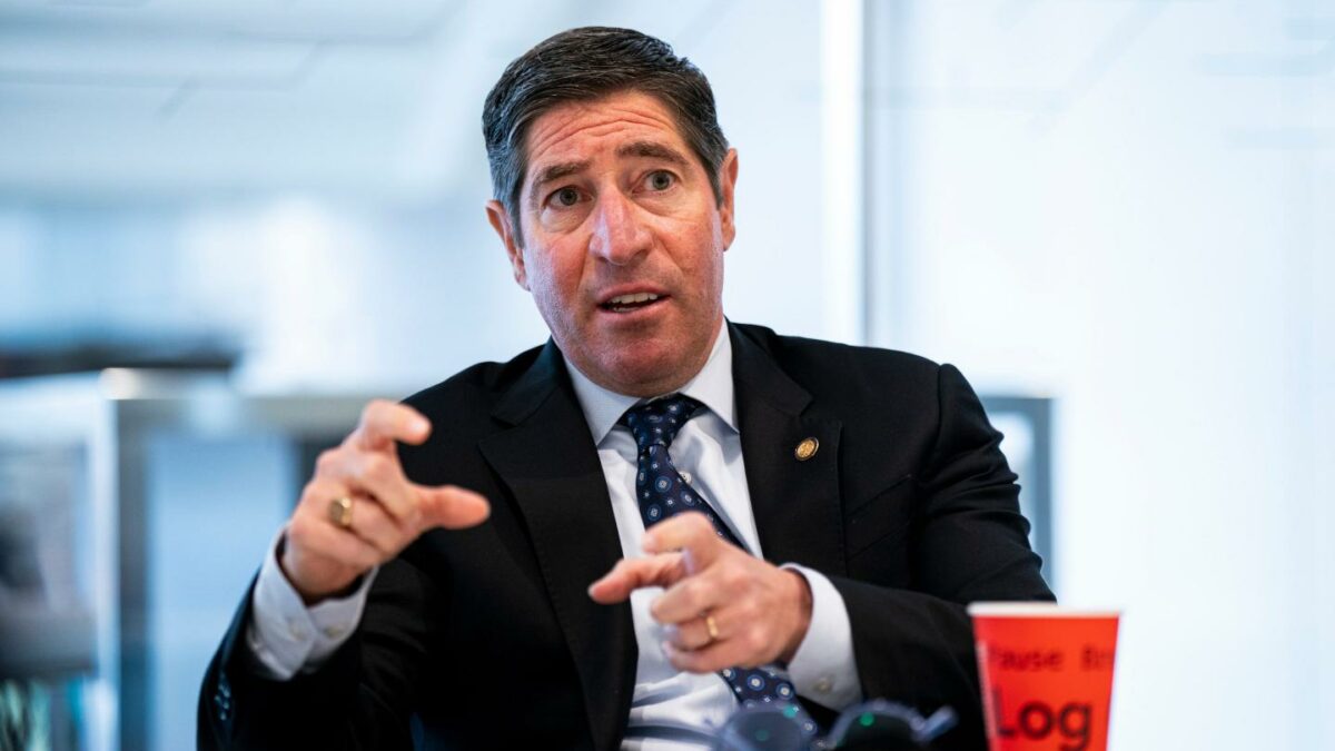 Scott Kupor sits at a table gesturing with both hands.