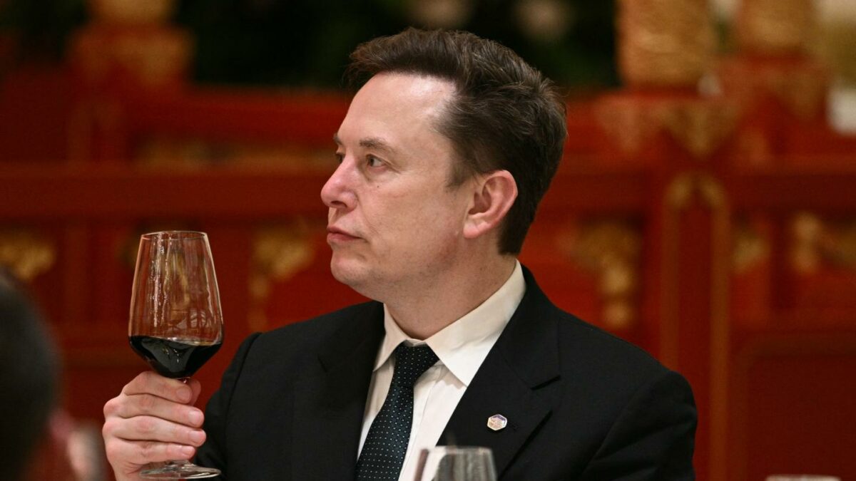 Elon Musk holding a glass of wine during a U.S. diplomatic visit to China