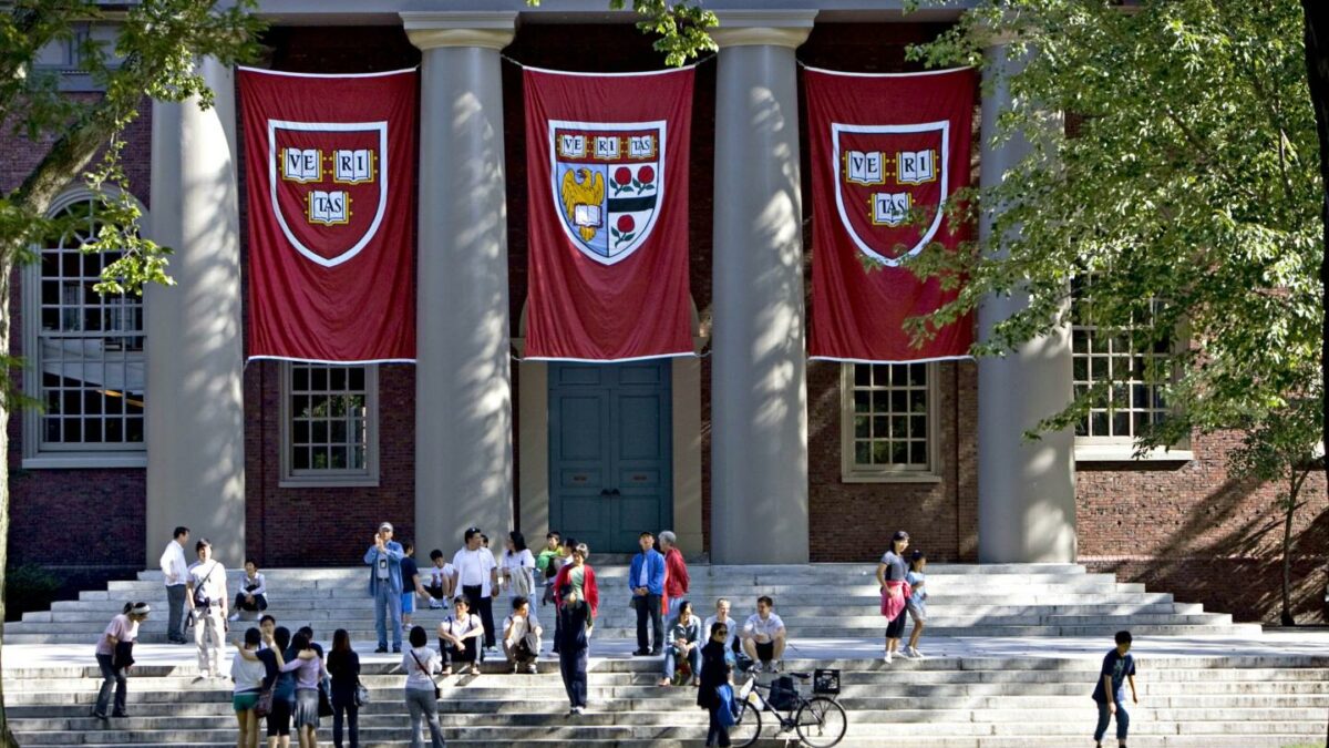 Harvard University banners hang in front of a building